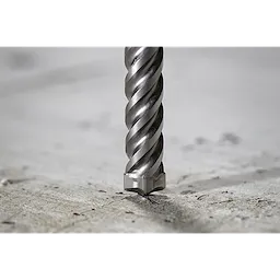 The MILWAUKEE® SDS-PLUS 4-Cutter MX4™ 3/4" X 8" X 10" Drill Bits drilling into concrete