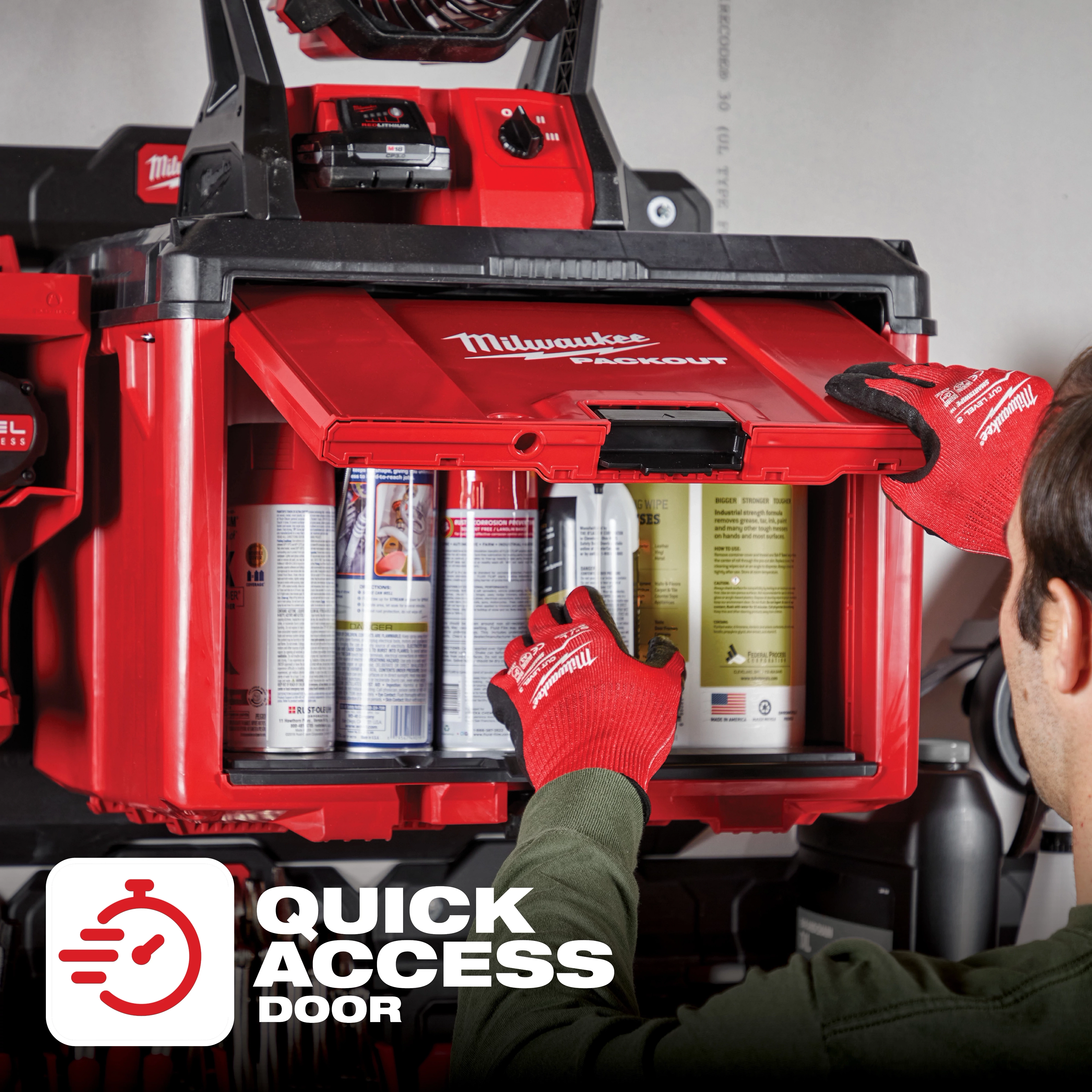 Person opening the Quick Access Door on a Milwaukee Packout storage unit, wearing red gloves and revealing various spray cans inside.