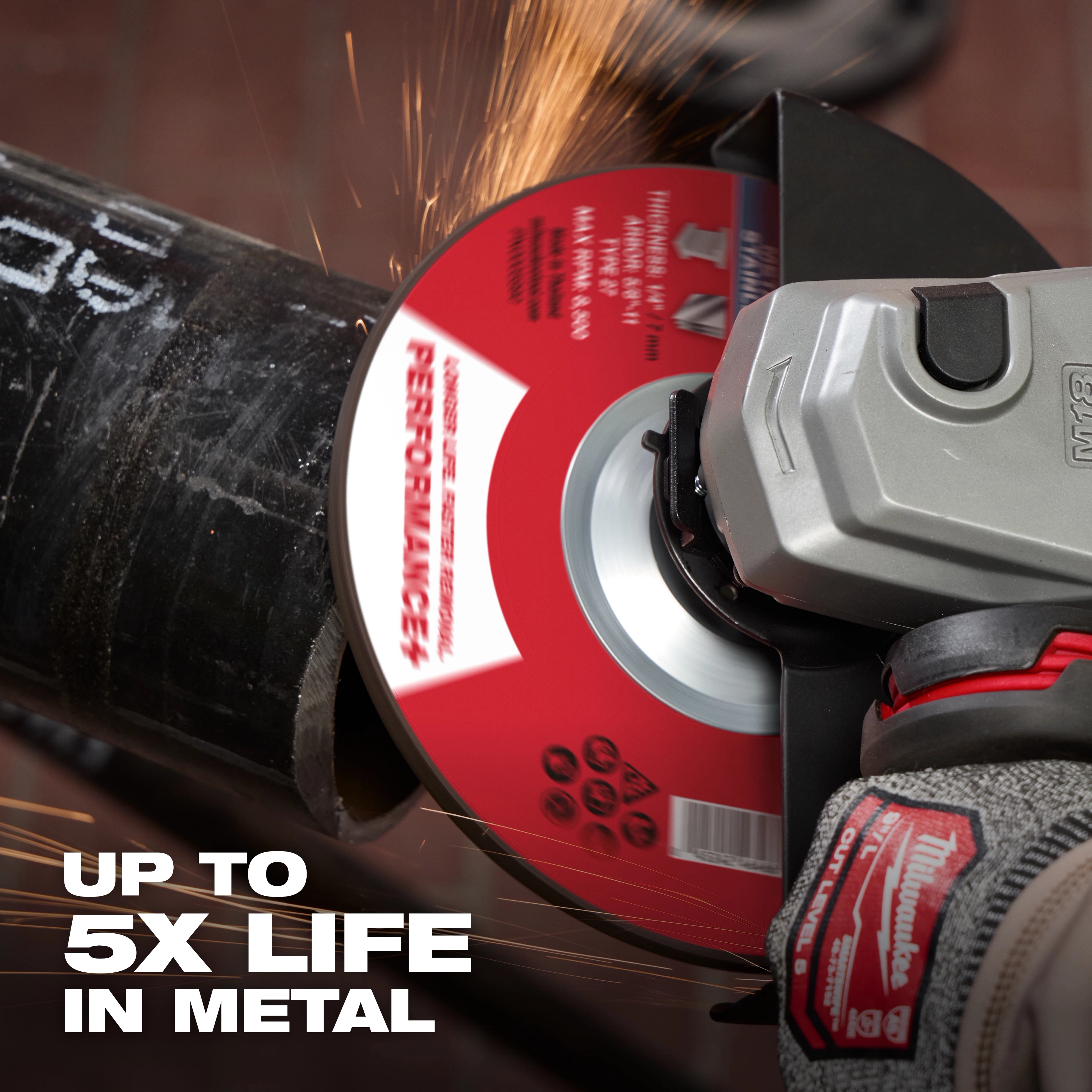 Bonded Abrasives Grinding disc in use, grinding a metal pipe, with sparks flying. Text on image reads "UP TO 5X LIFE IN METAL".
