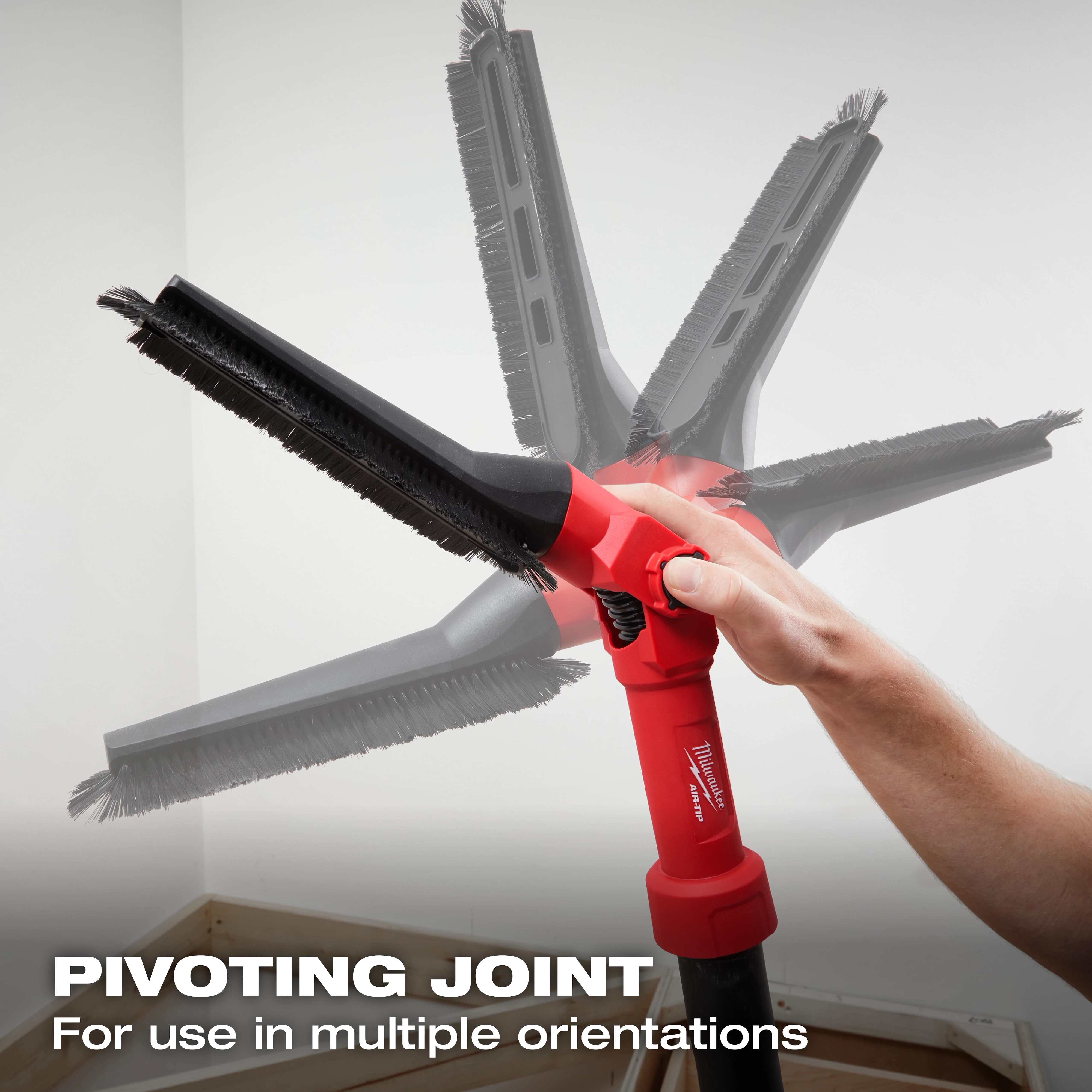 A hand holding the AIR-TIP™ Low-Profile Pivoting Brush Tool. The tool features a pivoting joint for use in multiple orientations, as demonstrated by the ghosted images of the brush head in different positions. Text at the bottom reads "PIVOTING JOINT For use in multiple orientations."