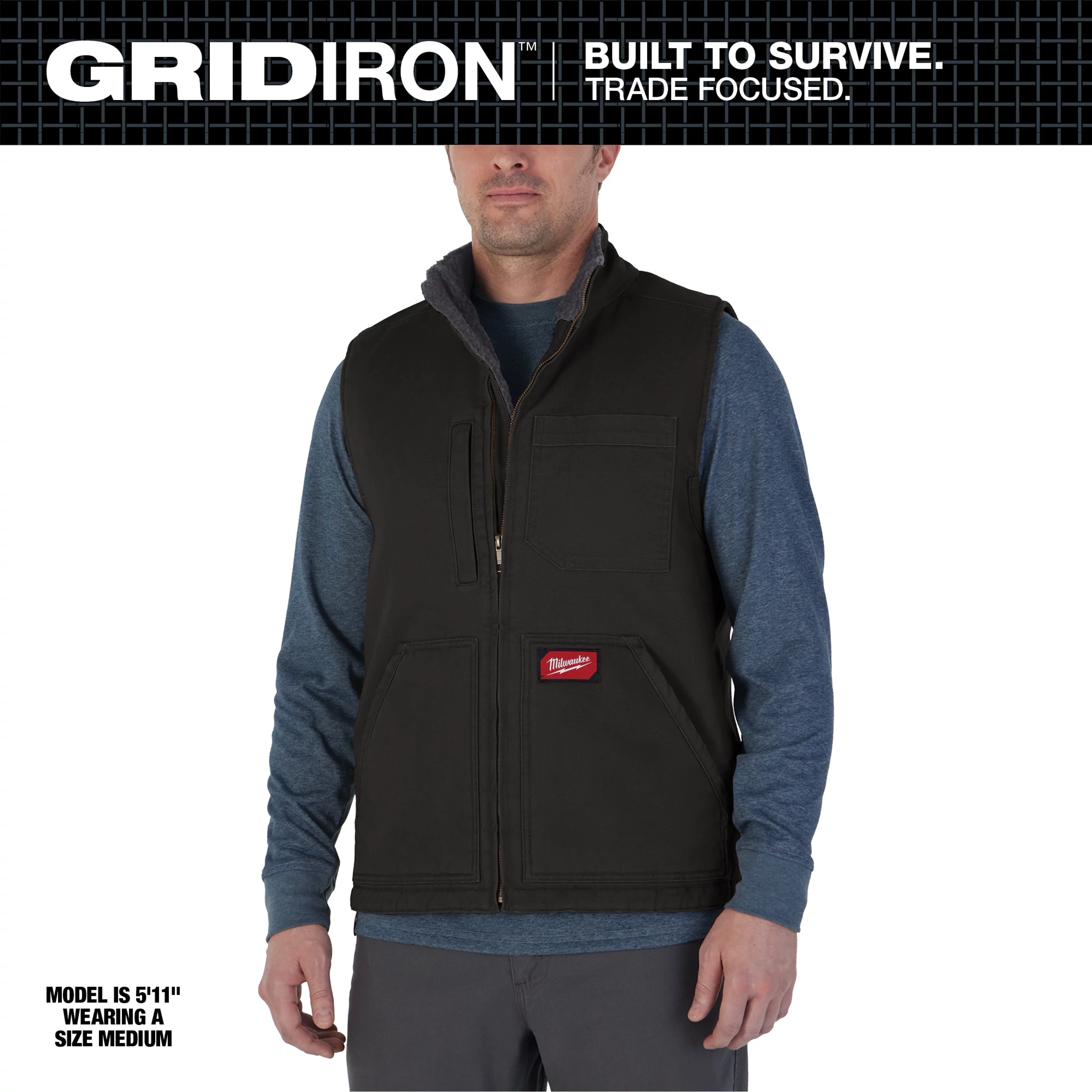 Heavy Duty Sherpa-Lined Vest in black, worn by a model. The vest has multiple pockets and a front zipper, size medium.