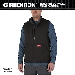 Heavy Duty Sherpa-Lined Vest in black, worn by a model. The vest has multiple pockets and a front zipper, size medium.