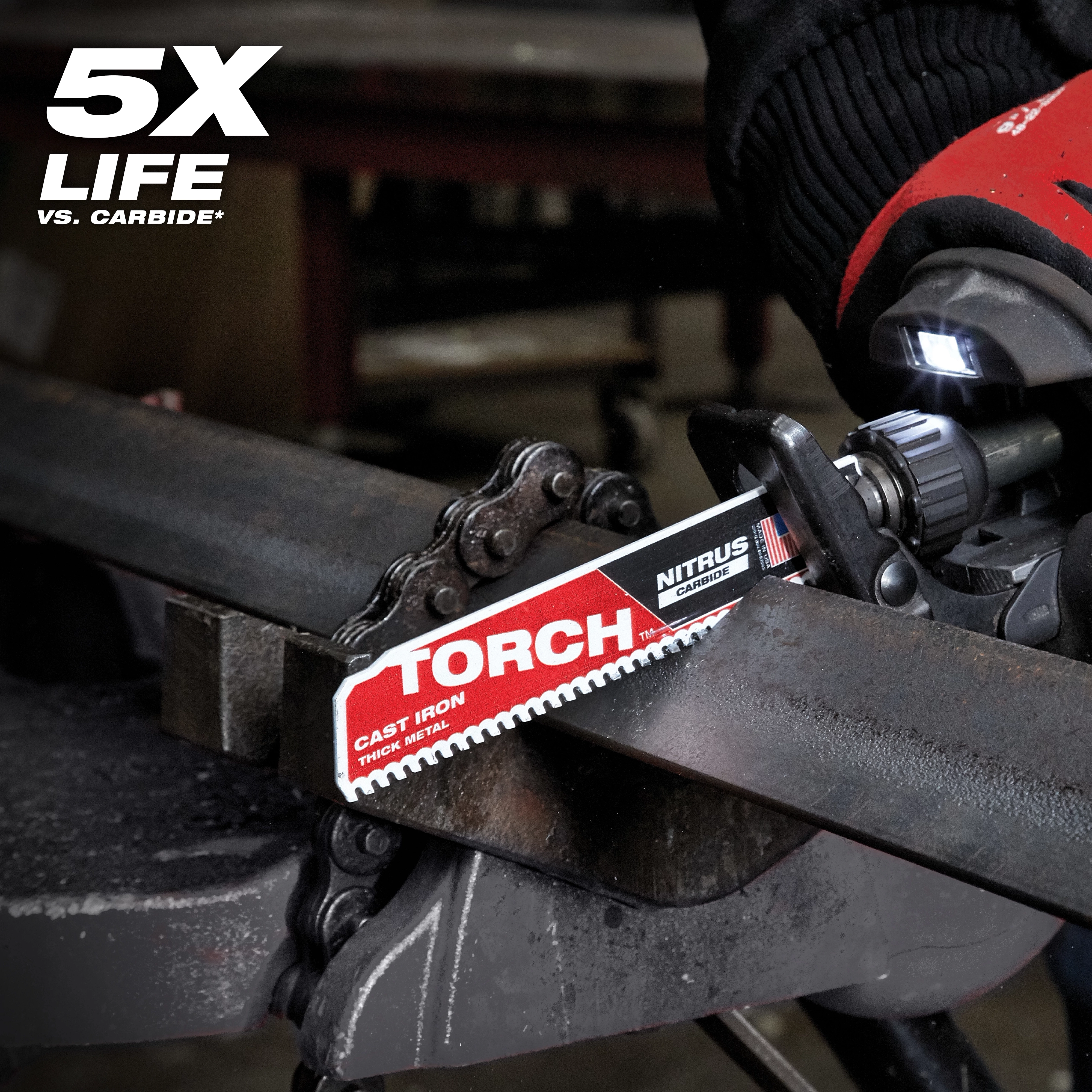 Nitrus Carbide Life Claim TORCH saw blade cutting through thick metal. The blade sits in a machine, held by a gloved hand. Text in the top left corner indicates "5X LIFE." The product is designed for cast iron and thick metal.